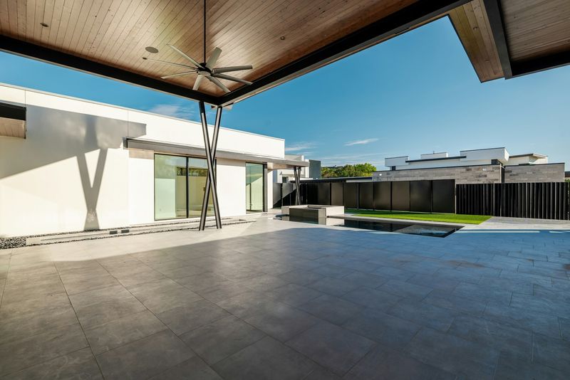 Modern patio and pool area shaded by an aluminum louvered structure